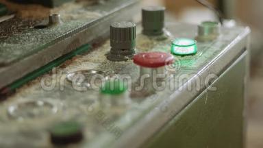 在锯木厂用按钮在控制面板上闪烁绿色灯泡